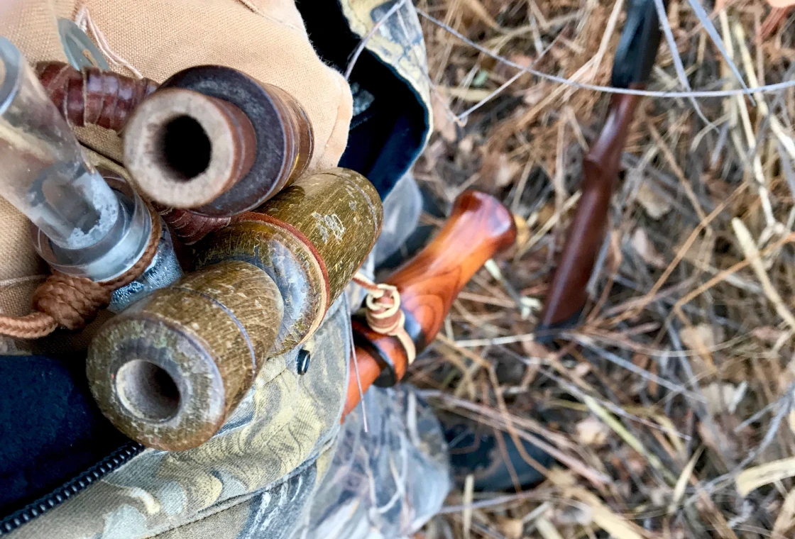Hunting gear with rifle and camouflage clothing.